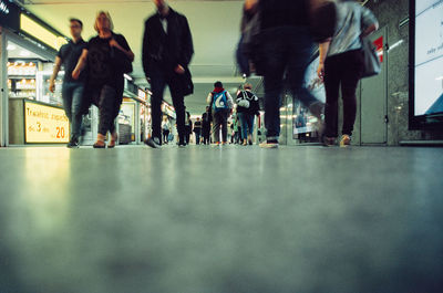 Group of people walking on sidewalk in city