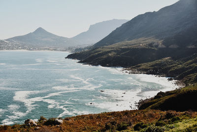 Scenic view of sea and mountains against sky