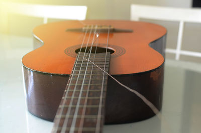 Close-up of guitar on table