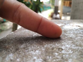 Close-up of person hand on table