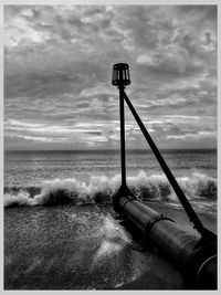 Lifeguard hut at beach against sky