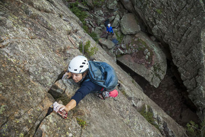Woman rock climbs matron north face, flatirons near boulder, colorado