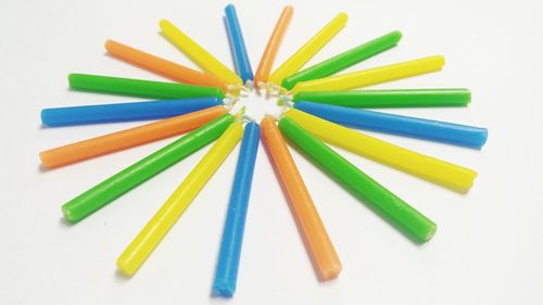 High angle view of colored pencils on white background