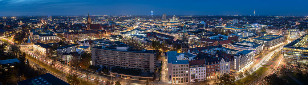 High angle view of city lit up at night