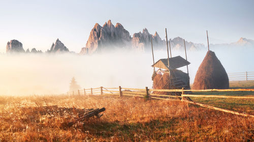 Scenic view of field against sky and mountains