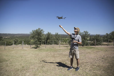 Man with drone on field