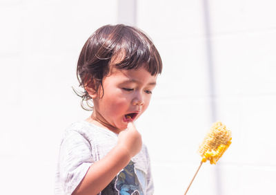 Close-up of girl eating food at home