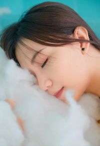 Close-up of young woman embracing cotton