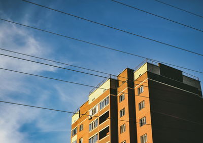 Low angle view of buildings against blue sky