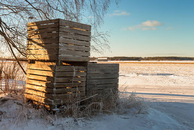 Built structure on field against sky during winter