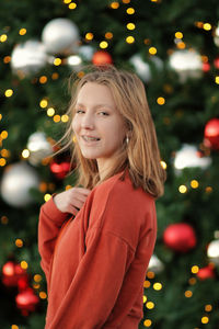 Girl looking at illuminated christmas tree