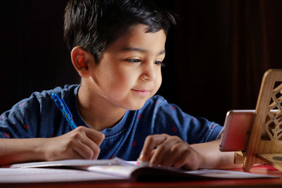 Child studying with smile on his face-hd image