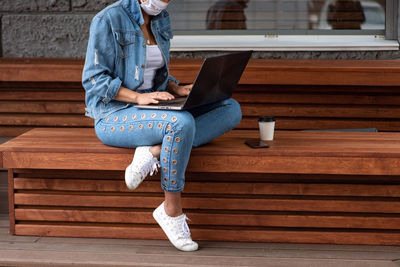 Woman using laptop outdoors