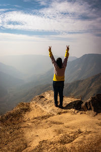 Full length rear view of man standing on mountain