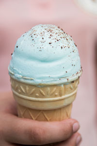 Close-up of hand holding ice cream