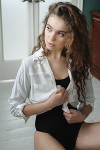 Portrait of young woman sitting at home