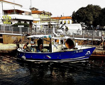 Boats moored at harbor against clear sky