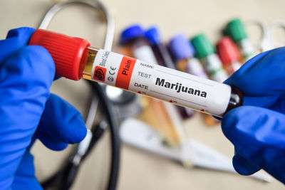 Midsection of scientist examining chemical