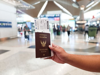 Cropped hand of woman holding mobile phone