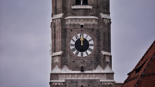 Low angle view of clock tower against sky