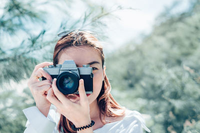 Portrait of woman photographing