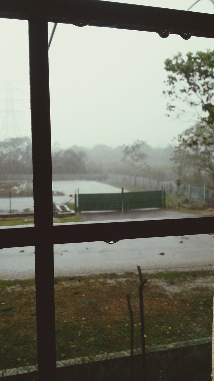 fence, tree, mountain, fog, landscape, window, field, nature, tranquility, sky, built structure, railing, day, no people, foggy, tranquil scene, indoors, water