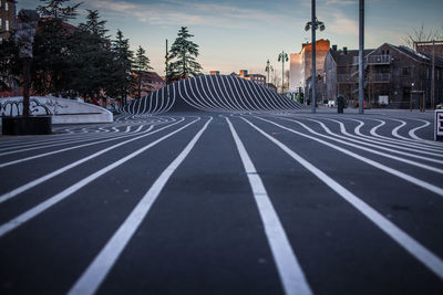 Road by city against sky