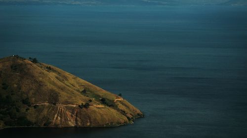 Scenic view of sea and mountains against sky