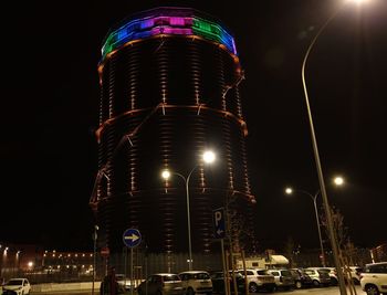 Low angle view of illuminated street against sky at night