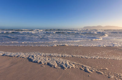 Scenic view of sea against clear blue sky