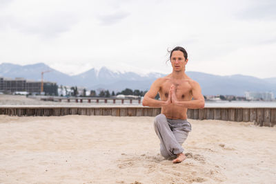 Portrait of young man standing on beach