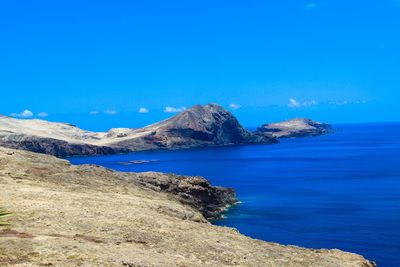 Scenic view of sea against clear blue sky