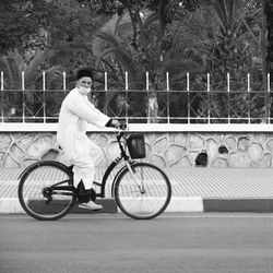 Side view of woman riding bicycle