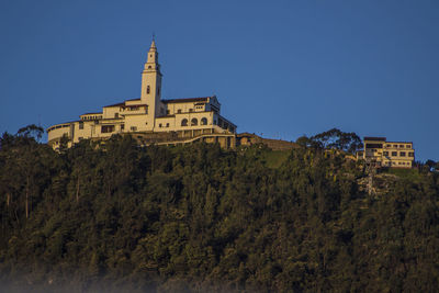 Low angle view of historic church on monserrate against clear blue sky