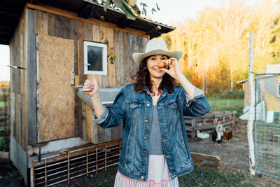 With a beaming smile, a hobby woman farmer displays a perfect egg