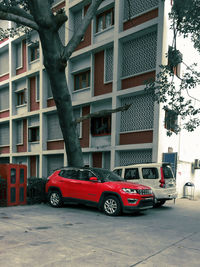 Car on street against buildings in city