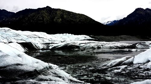 Scenic view of frozen lake against mountain range