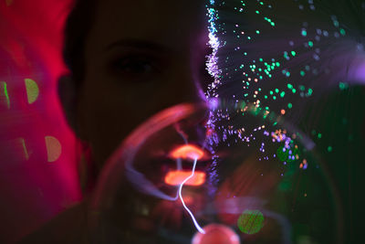 Close-up portrait of woman with illuminated light painting