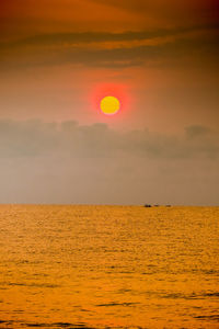 Scenic view of sea against orange sky