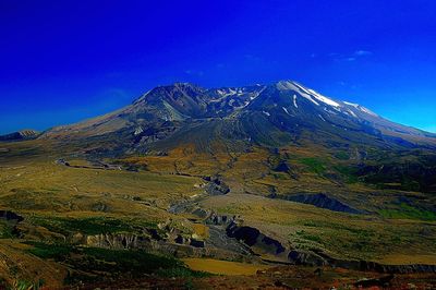 View of mountain range against blue sky