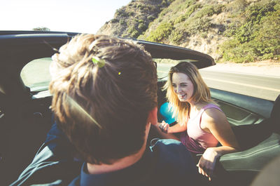 Rear view of women sitting in car