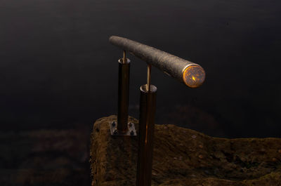 Close-up of old rusty metal pole against wall