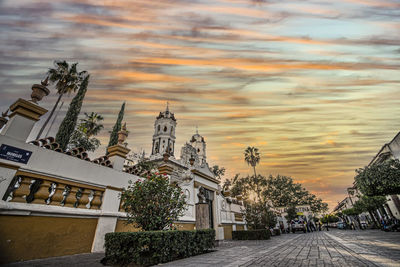 Panoramic view of buildings and trees against sky