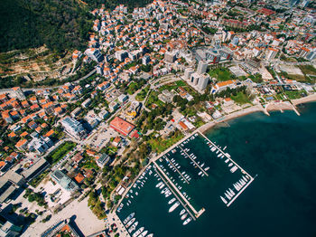 High angle view of townscape by river in city