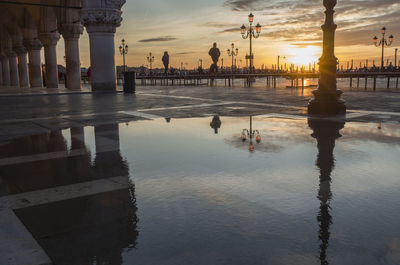 Reflection of building in water at sunset