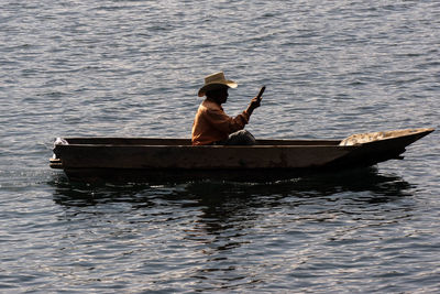 Man and woman in boat sailing on sea