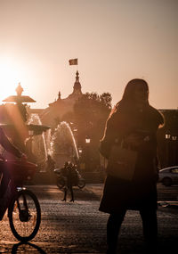 People riding motorcycle on street against sky