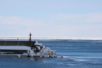 Scenic view of sea against sky during winter