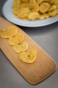 High angle view of puff pastries arranged on cutting board at table