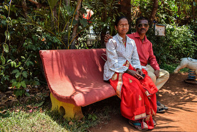 Portrait of a smiling girl sitting outdoors